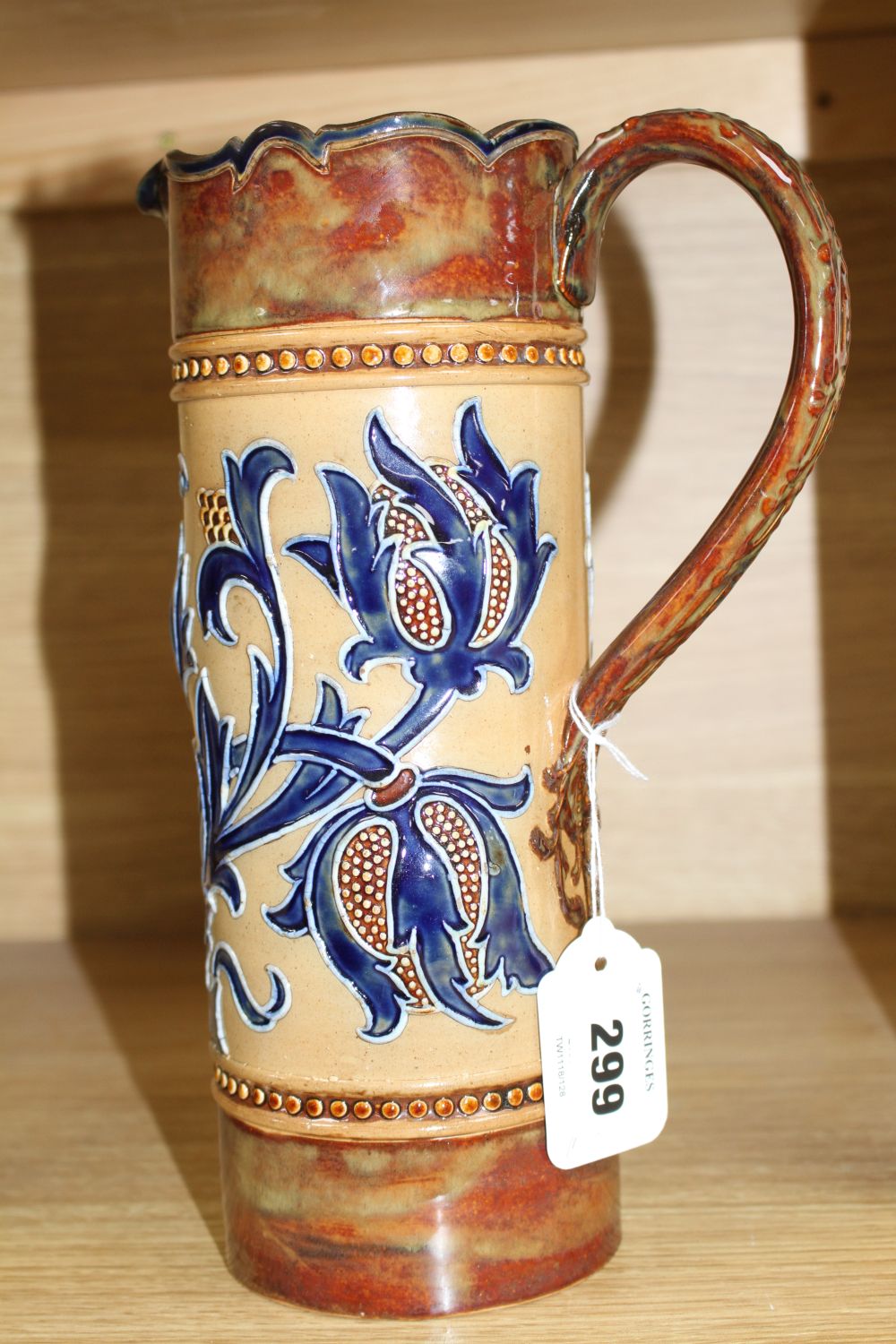 Mark V. Marshall for Doulton Lambeth, an Art Union of London jug, c.1895, the cylindrical body tube-lined with spikey flower and leaves